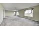 Bright living room with neutral paint, large windows, and plush carpeting, creating a warm and welcoming space at 1502 W 525 N, Lebanon, IN 46052