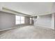Spacious living room with neutral carpet, gray walls, white trim, and a large window for ample natural light at 1502 W 525 N, Lebanon, IN 46052