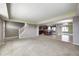 Open-concept living room that flows into kitchen featuring neutral walls and carpet and access to the entryway at 1502 W 525 N, Lebanon, IN 46052