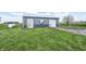 Shed with two tones of blue on the walls, a metal roof, and an adjacent propane tank at 1502 W 525 N, Lebanon, IN 46052