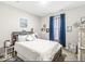 Serene bedroom showcasing a rustic wooden headboard and cozy blue curtains at 17865 Haralson Row, Westfield, IN 46074