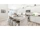 Modern kitchen featuring white cabinets, stainless steel appliances, an island with seating, and ample counter space at 17865 Haralson Row, Westfield, IN 46074