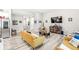 Open-concept living room with hardwood floors, modern furnishings, and a large television at 17865 Haralson Row, Westfield, IN 46074