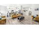 Open-concept living room showcasing modern decor, hardwood floors, and seamless flow into the kitchen at 17865 Haralson Row, Westfield, IN 46074