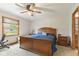 Bedroom featuring a wooden bed frame, plush carpeting and view of exterior at 1864 Holiday Pines Dr, Brownsburg, IN 46112