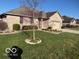 Brick home with attached garage, landscaped yard, and inviting curb appeal at 1864 Holiday Pines Dr, Brownsburg, IN 46112