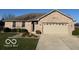 Charming brick home featuring an attached two car garage, well manicured lawn, and mature landscaping at 1864 Holiday Pines Dr, Brownsburg, IN 46112