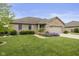 Beautifully landscaped brick home with a two-car garage, showcasing curb appeal at 1864 Holiday Pines Dr, Brownsburg, IN 46112