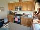 Well-equipped kitchen with wood cabinets, granite countertops, and stainless steel appliances at 1864 Holiday Pines Dr, Brownsburg, IN 46112