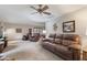 Bright and airy living room with a ceiling fan and cozy seating area at 1864 Holiday Pines Dr, Brownsburg, IN 46112