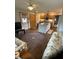 Inviting living room with a large round rug and view into the well-lit kitchen at 1864 Holiday Pines Dr, Brownsburg, IN 46112