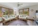 Cozy sunroom with stylish sofas, natural light, and views of the outdoors at 1864 Holiday Pines Dr, Brownsburg, IN 46112