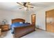 Spacious main bedroom with a wooden bed frame, ceiling fan, and ensuite access at 1864 Holiday Pines Dr, Brownsburg, IN 46112
