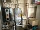 Utility room contains the homes furnace, water heater, water softener, and laundry tub at 1864 Holiday Pines Dr, Brownsburg, IN 46112