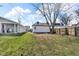 Grassy backyard with privacy fence, lawn, and garage provides a suburban oasis for outdoor enjoyment at 1924 S A St, Elwood, IN 46036
