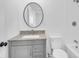 Well-lit bathroom features a modern vanity with gray cabinets and a matching granite countertop at 1924 S A St, Elwood, IN 46036