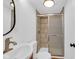 Bathroom with tile surround shower, stylish sink, and bronze fixtures provides a modern feel at 1924 S A St, Elwood, IN 46036