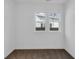 Bright bedroom with plush carpet and two windows offering natural light and backyard views at 1924 S A St, Elwood, IN 46036