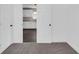 Cozy bedroom showcasing an open doorway to the kitchen area with white cabinets and dark floors at 1924 S A St, Elwood, IN 46036