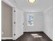 Clean bedroom with dark hardwood floors, fresh paint, and natural light from a new window at 1924 S A St, Elwood, IN 46036