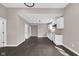 Modern kitchen features white cabinets, stainless steel appliances, and dark hardwood flooring at 1924 S A St, Elwood, IN 46036