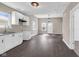 Open floor plan features a new kitchen, stainless fixtures, gray countertop and dark hardwood flooring at 1924 S A St, Elwood, IN 46036