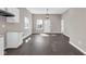 Open-concept living space with dark hardwood floors, a modern light fixture, and neutral walls at 1924 S A St, Elwood, IN 46036