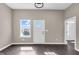 Inviting living room featuring dark hardwood floors, fresh paint, and an abundance of natural light at 1924 S A St, Elwood, IN 46036