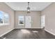 Bright living room with dark hardwood floors, new windows, and modern light fixture at 1924 S A St, Elwood, IN 46036