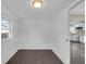 Bright room featuring dark hardwood flooring, white walls, and a large window at 1924 S A St, Elwood, IN 46036