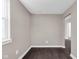 Room featuring dark wood flooring, neutral walls, and bright window offering views of the outside at 1924 S A St, Elwood, IN 46036