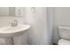 Compact powder room with a pedestal sink, round mirror and toilet at 1924 White Oak Ln, Shelbyville, IN 46176