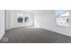 Spacious bedroom featuring large windows for natural light, carpeted flooring, and white walls at 1924 White Oak Ln, Shelbyville, IN 46176