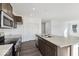 View of kitchen with island, sink, range, microwave, cabinets, and hardwood floors at 1924 White Oak Ln, Shelbyville, IN 46176