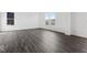 Open-concept living room with luxury vinyl plank flooring and lots of natural light from multiple windows at 1924 White Oak Ln, Shelbyville, IN 46176