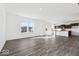 Bright, open-concept living area with wood flooring and abundant natural light from large windows overlooking the front yard at 1924 White Oak Ln, Shelbyville, IN 46176