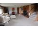 Spacious carpeted basement with fireplace, white sofa, and hanging chair at 1936 Cunningham Rd, Indianapolis, IN 46224