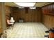 Unfinished basement with checkered floors and a chair next to the wall at 1936 Cunningham Rd, Indianapolis, IN 46224