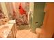 Cozy bathroom with a shower, toilet, sink, and some storage at 1936 Cunningham Rd, Indianapolis, IN 46224