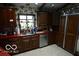 Bright kitchen with wooden cabinets, stainless steel appliances, and red countertops at 1936 Cunningham Rd, Indianapolis, IN 46224