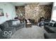 Inviting living room features a stone fireplace, cozy seating, and plenty of natural light at 1936 Cunningham Rd, Indianapolis, IN 46224