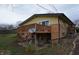 Back of house showing a wooden deck, outdoor patio with swing, and an outdoor dining set at 1936 Cunningham Rd, Indianapolis, IN 46224