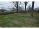 A spacious, grassy backyard is enclosed by a wooden fence at 1936 Cunningham Rd, Indianapolis, IN 46224