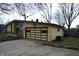 Ranch style home featuring a garage, unique roofline, and well-maintained landscaping at 1936 Cunningham Rd, Indianapolis, IN 46224