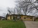 Beautiful single-story home featuring a well-manicured lawn and inviting driveway at 1936 Cunningham Rd, Indianapolis, IN 46224