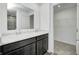 Elegant bathroom with double sinks, marble countertop, dark cabinets, and walk-in closet at 1952 White Oak Ln, Shelbyville, IN 46176
