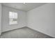 Bright bedroom featuring neutral carpet, a large window, and crisp white walls at 1952 White Oak Ln, Shelbyville, IN 46176