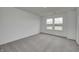 Bright bedroom with plush carpeting, a window, and a scenic outdoor view at 1952 White Oak Ln, Shelbyville, IN 46176
