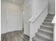 Open entryway with hardwood-style floors, carpeted stairs, and bright white trim at 1952 White Oak Ln, Shelbyville, IN 46176