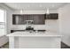 Modern kitchen featuring dark cabinets, stainless steel appliances, and an island with marble countertop at 1952 White Oak Ln, Shelbyville, IN 46176